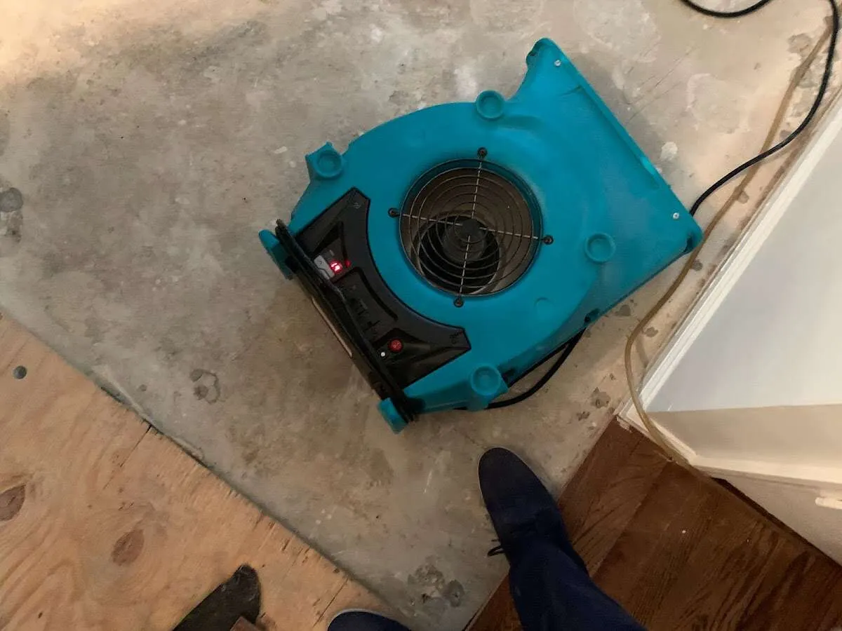 Air mover drying subfloor during Commercial Water Damage Restoration in Westerly